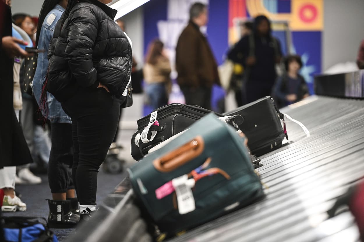 Passengers wait for the their luggage at the arrival terminal inside Laguardia Airport in December 2022.