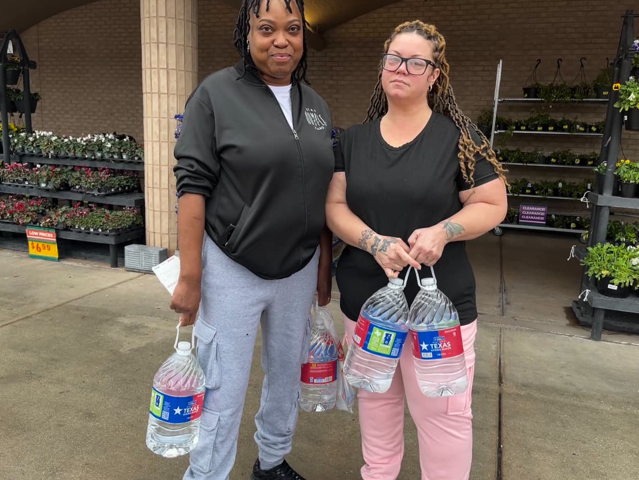 Nu Riley and Scarlet Riley hold water bottles outside of shopping center.