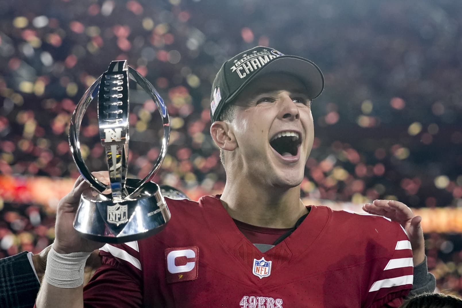 San Francisco 49ers quarterback Brock Purdy celebrates with the trophy after their win against the Detroit Lions in the NFC Championship NFL football game in Santa Clara, Calif., Sunday, Jan. 28, 2024.