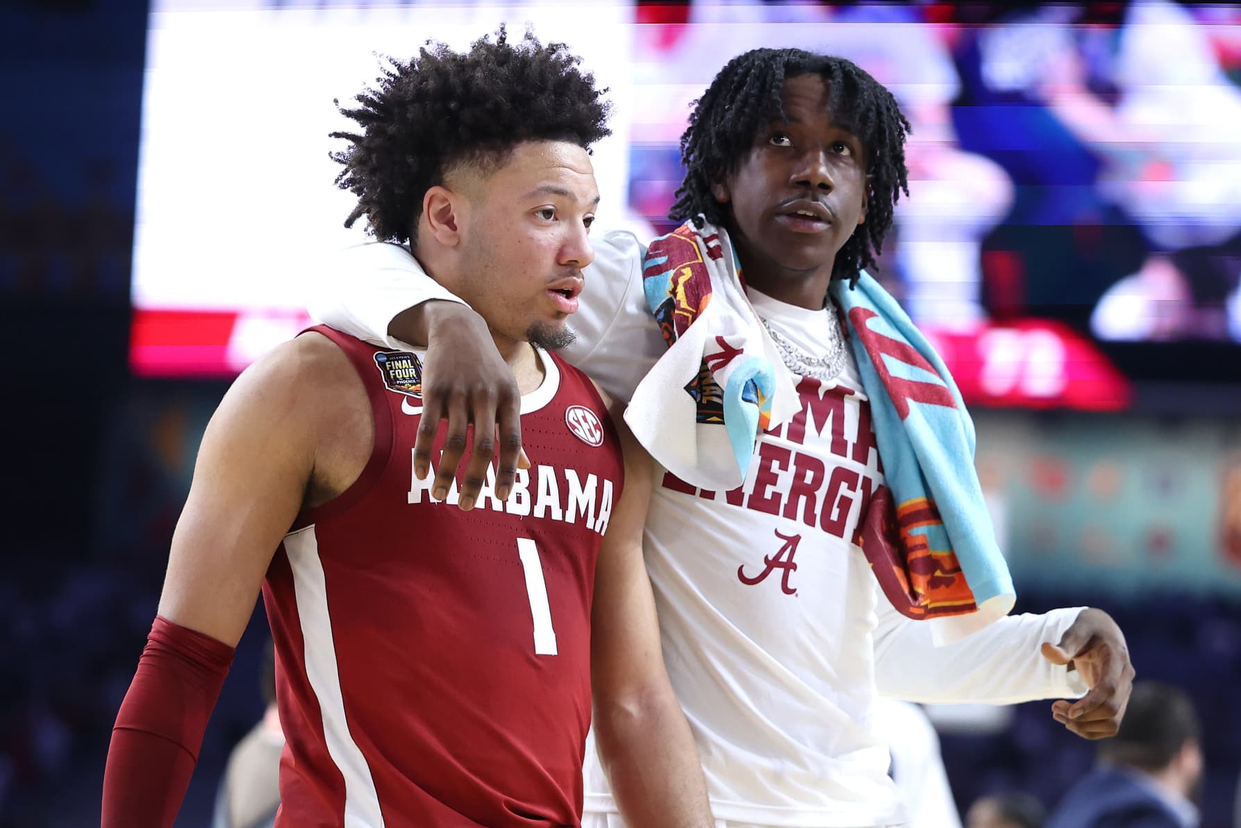 Mark Sears, left, of the Alabama Crimson Tide walks off the court after losing to the Connecticut Huskies 86-72 in the NCAA Men's Final Four game at State Farm Stadium on April 6, 2024 in Glendale, Ariz. 