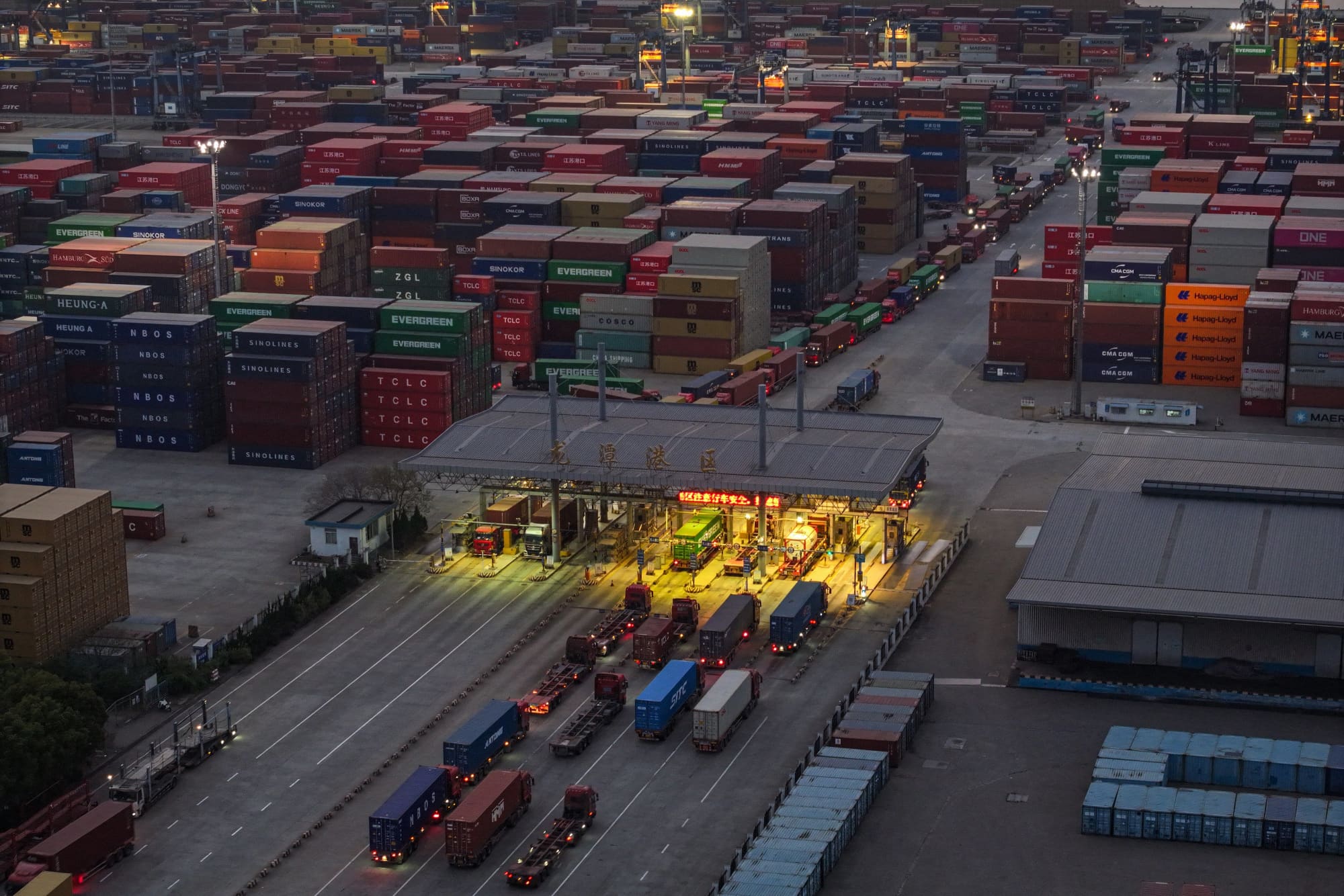 Trucks and shipping containers are seen at a port in Nanjing, in eastern China's Jiangsu province on April 8, 2025.