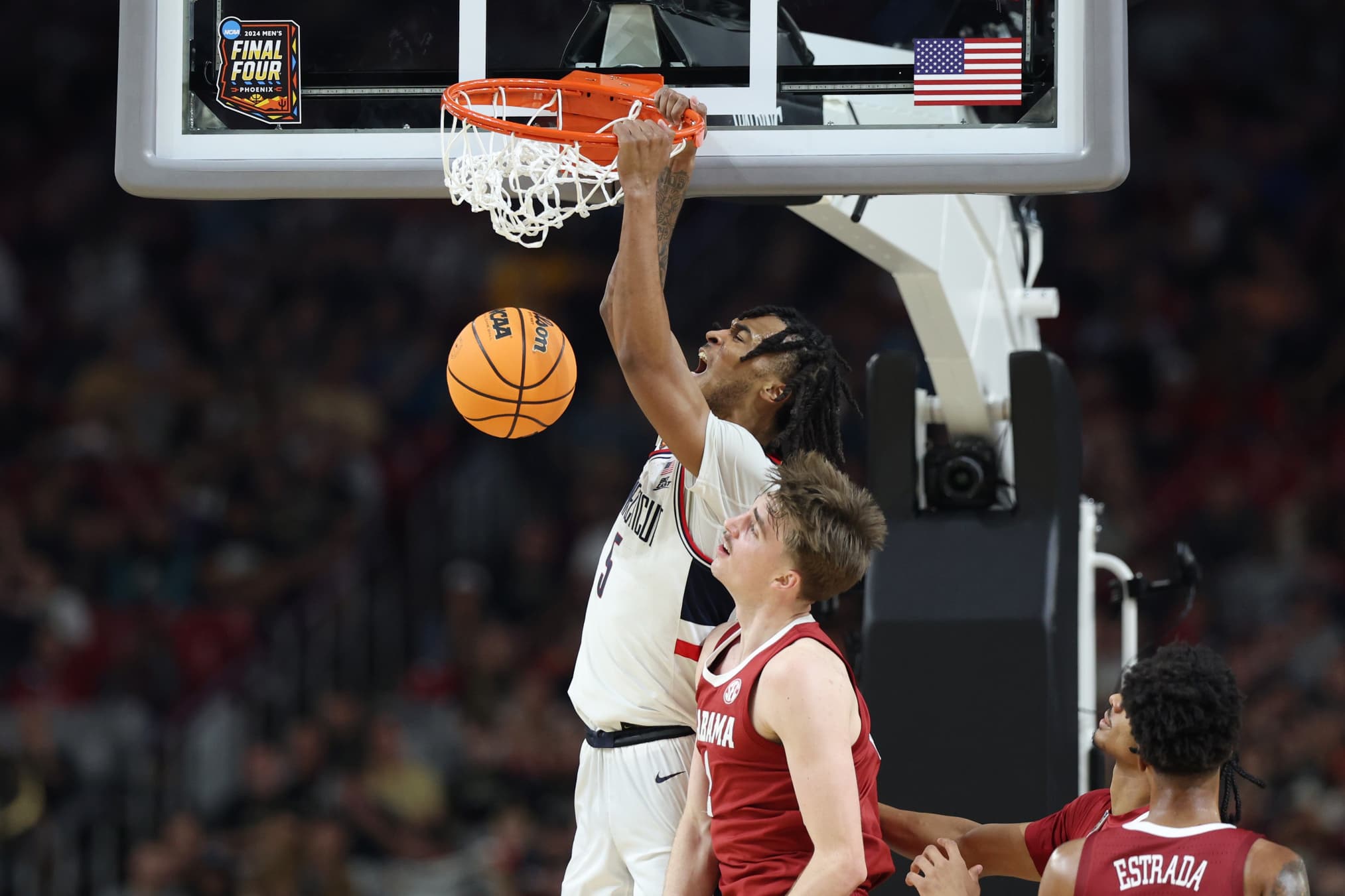 Stephon Castle of UConn dunks the ball in the second half against Alabama in the NCAA Men's Final Four game at State Farm Stadium on April 6, 2024 in Glendale, Ariz.