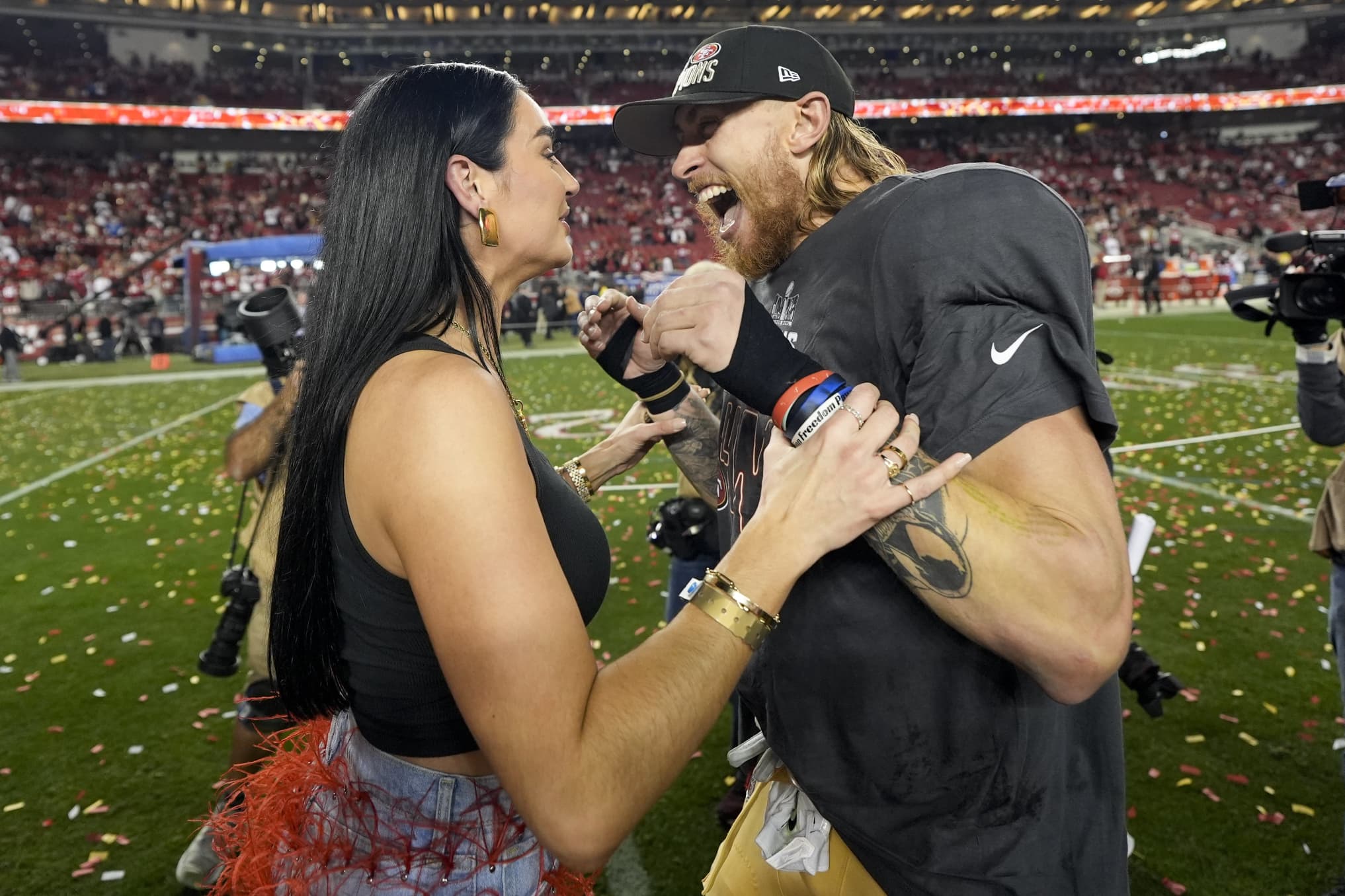 San Francisco 49ers tight end George Kittle celebrates with his wife Claire, after their win against the Detroit Lions in the NFC Championship NFL football game in Santa Clara, Calif., Sunday, Jan. 28, 2024. 