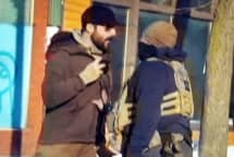 Alex Pretti, left, and a federal immigration agent before Pretti was shot dead in Minneapolis on Jan. 24, 2026.