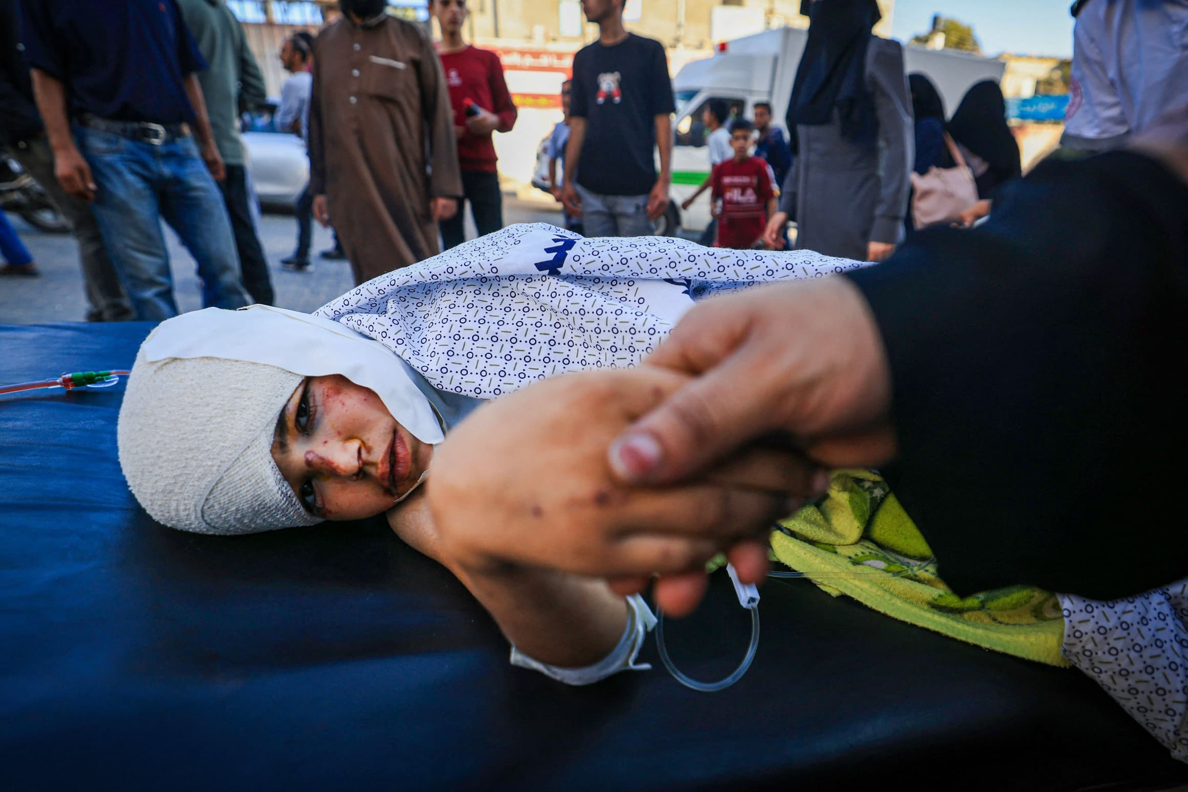 A mother comforts her child, who was wounded in an airstrike, at Nasser Hospital in Khan Yunis in the southern Gaza Strip on Oct. 20, 2023.