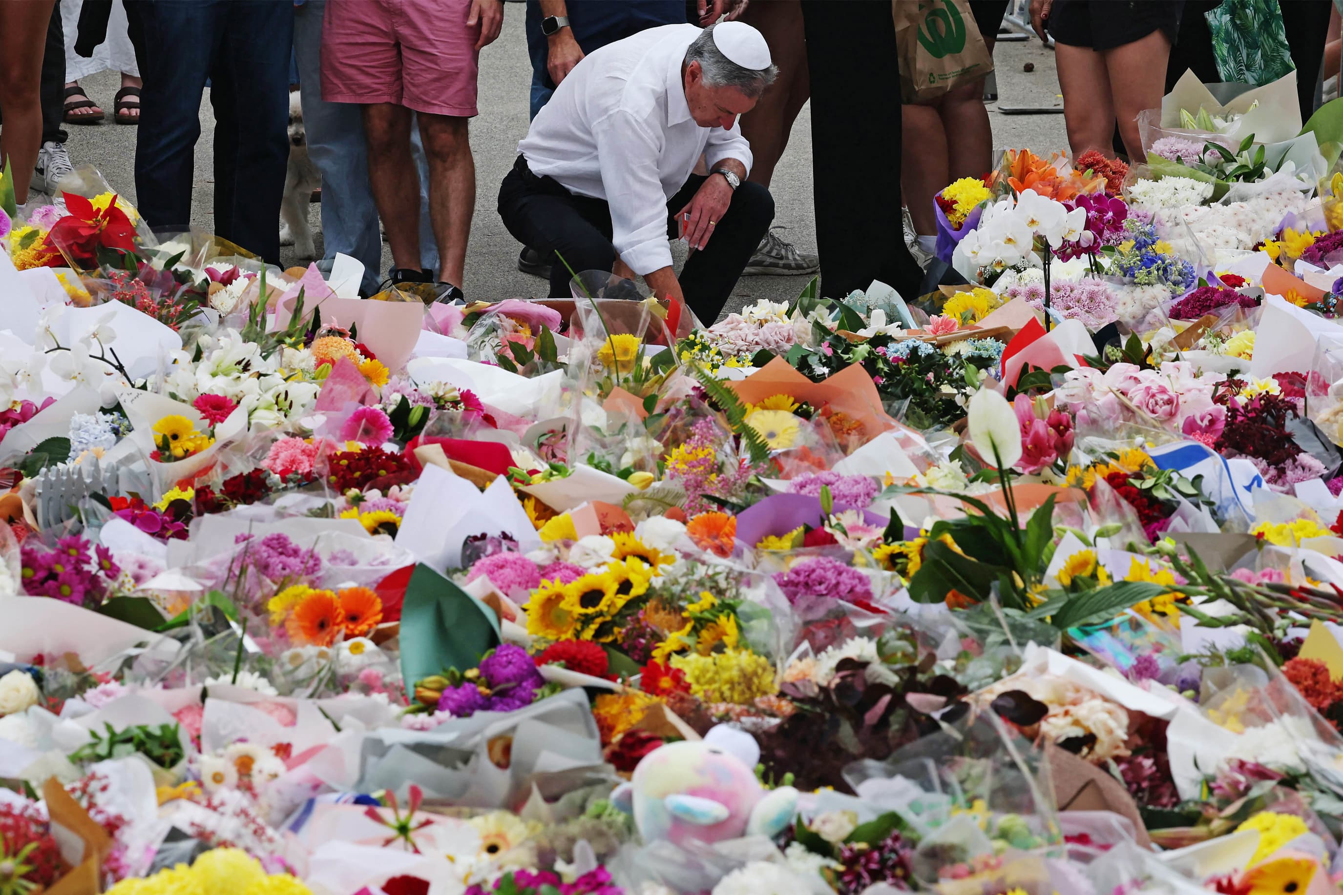 A member of the Jewish community places flowers at a memorial outside Bondi Pavilion in Sydney on Dec. 16, 2025.