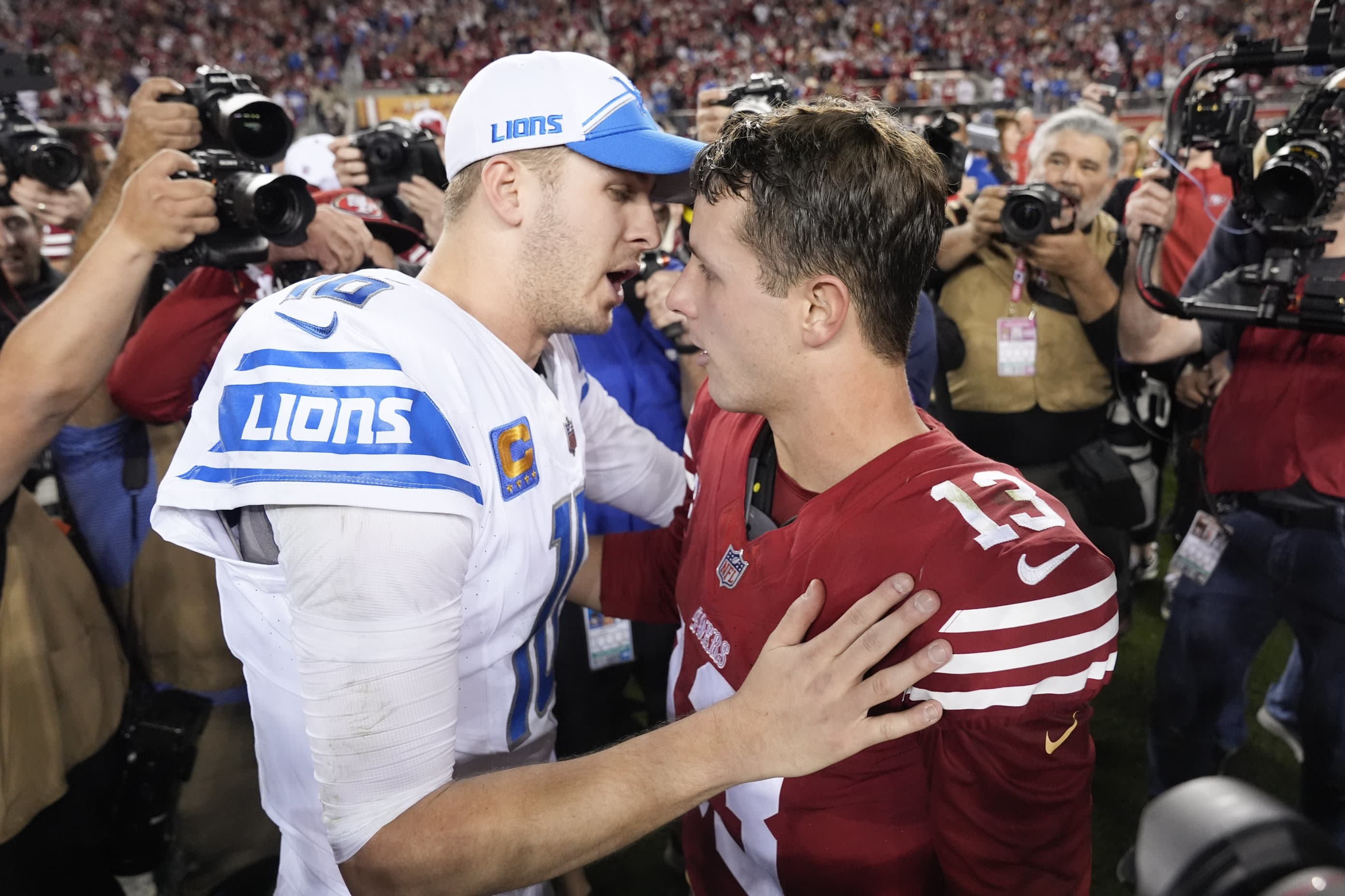 San Francisco 49ers quarterback Brock Purdy and Detroit Lions quarterback Jared Goff meet on the field after the NFC Championship NFL football game in Santa Clara, Calif., Sunday, Jan. 28, 2024. 