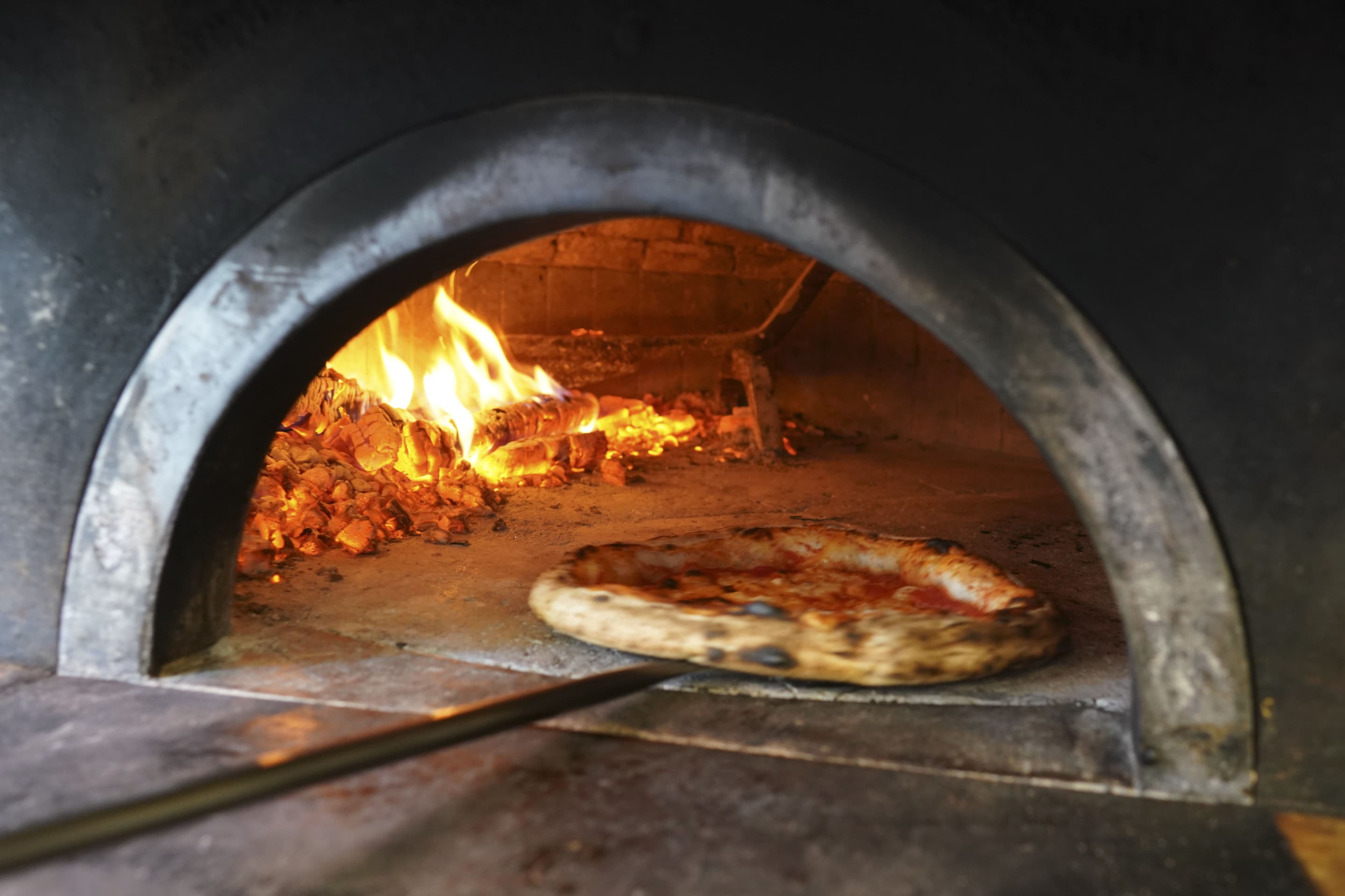 Image: Pizzas being prepared for home delivery at the Caputo pizzeria in Naples, Italy on Monday.