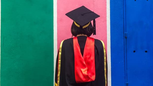 Rear View Of Person Wearing Graduation Gown