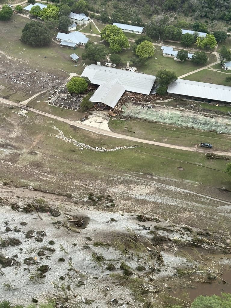 An aerial view of Camp La Junta outside, flood damage can be seen on the surrounding land