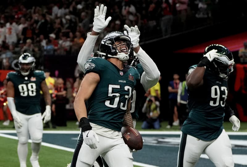 Zack Baun celebrates intercepting a pass from Patrick Mahomes.