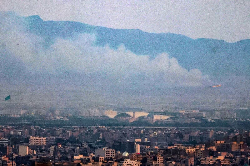 Smoke and fire billow from the site of an alleged Israeli strike in southern Tehran 