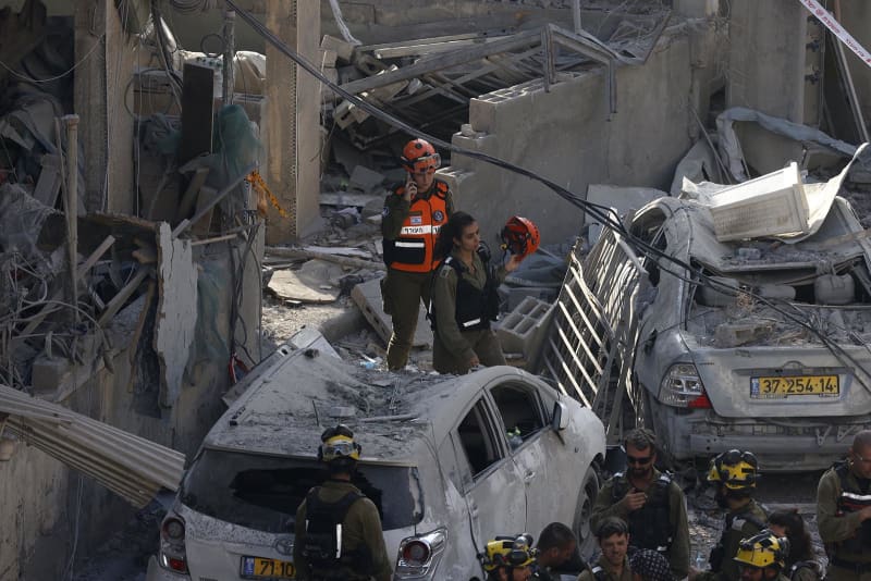 Israeli rescuers search through the rubble at the site of an Iranian missile strike in Bnei Brak on June 16, 2025.
