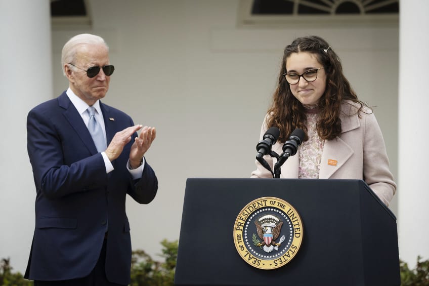 President Joe Biden applauds as Mia Tretta, speaks in the Rose Garden of the White House