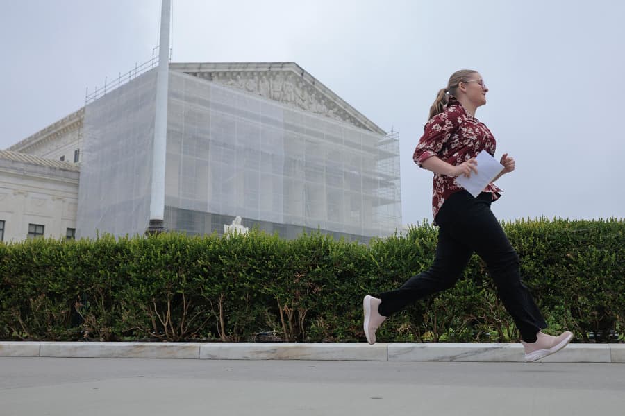 Often referred to as "the running of the interns," a journalist runs out of the U.S. Supreme Court building carrying an ruling during the last day of the court's term on June 27, 2025.