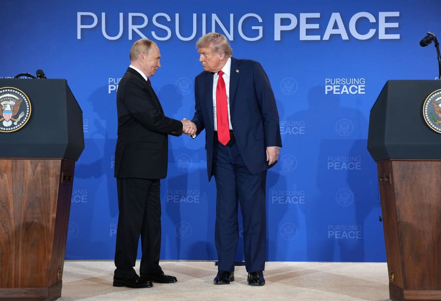 President Donald Trump and Russian President Vladimir Putin shake hands