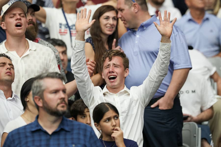 Audience members become emotional during the memorial service for political activist Charlie Kirk