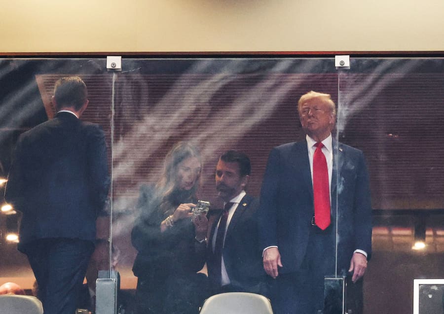 President Donald Trump, his son Eric Trump, Bettina Anderson and son Donald Trump Jr. attend the public memorial service for right-wing activist Charlie Kirk
