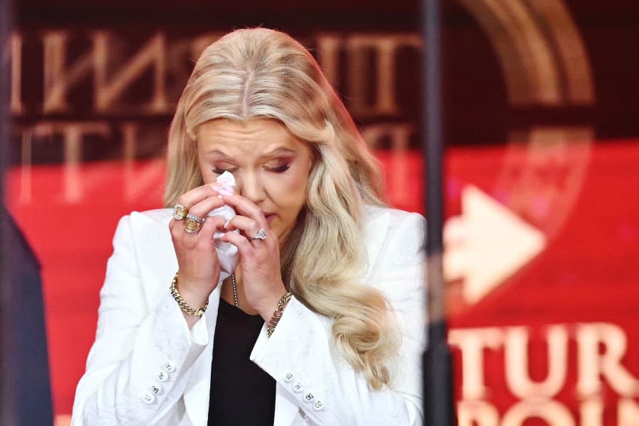 Erika Kirk, Charlie Kirk's widow, wipes away tears at his memorial