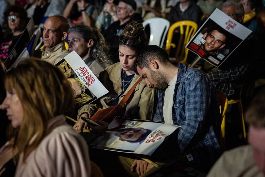 A couple sleeps while waiting for a live stream of the hostage releases to start at Hostages Square on Oct. 13, 2025 in Tel Aviv, Israel.