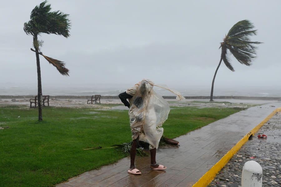 A man walks in Kingston, Jamaica, as Hurricane Melissa approaches, Tuesday, Oct. 28, 2025.