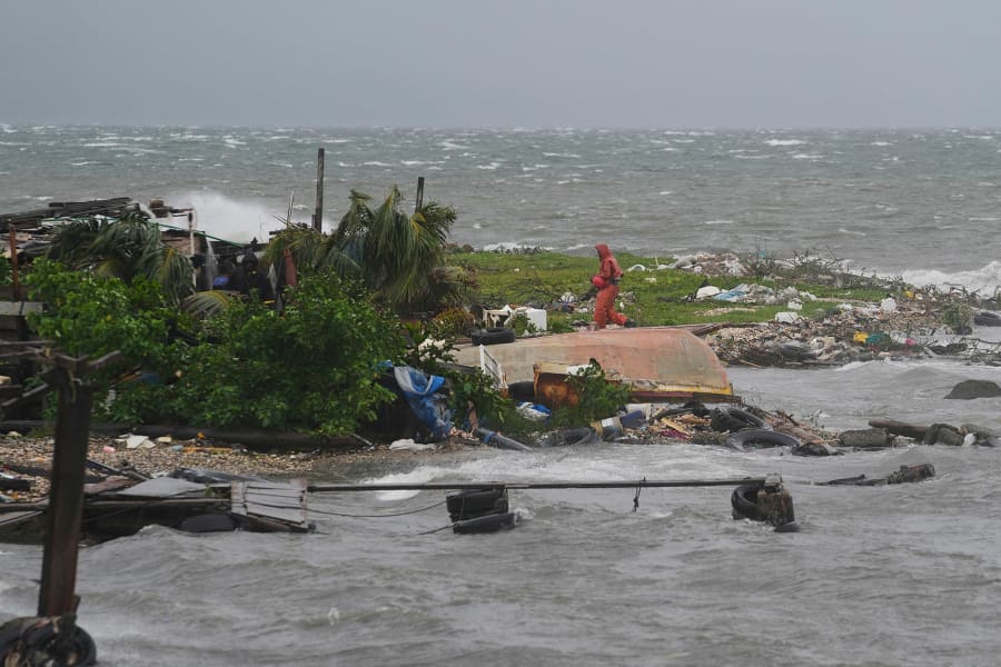 Damaged homes and fallen trees in Jamaica neighborhoods affected by Hurricane Melissa