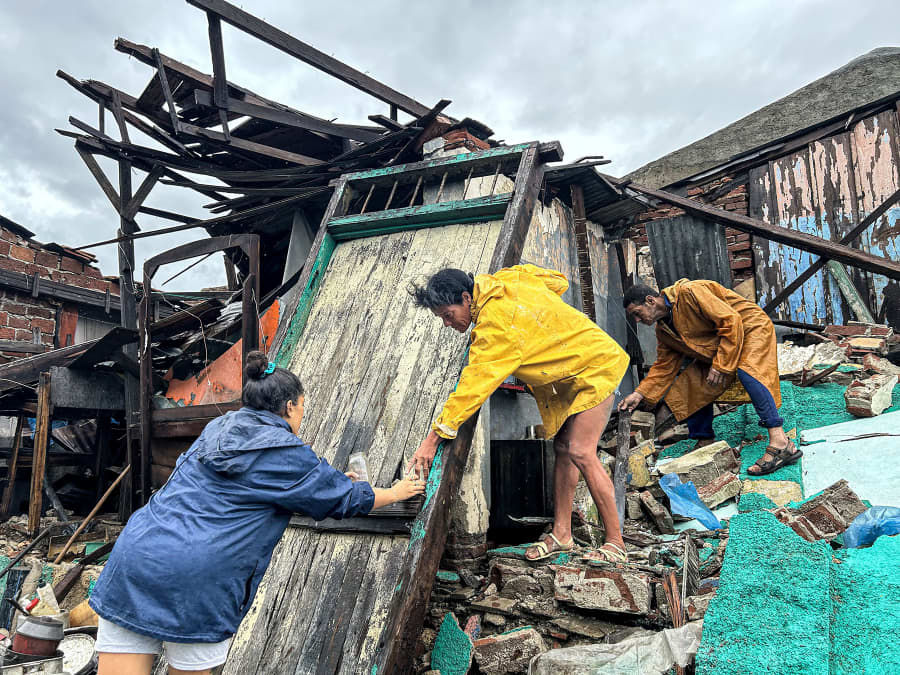 A family salvages belongings from the rubble of their home after it collapsed during Hurricane Melissa's passage through Santiago de Cuba, Cuba,