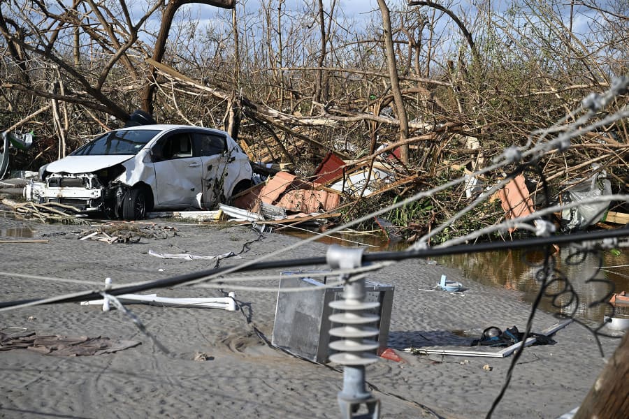 A car is surrounded by debris following the passage of Hurricane Melissa in Black River, Jamaica on October 29, 2025.