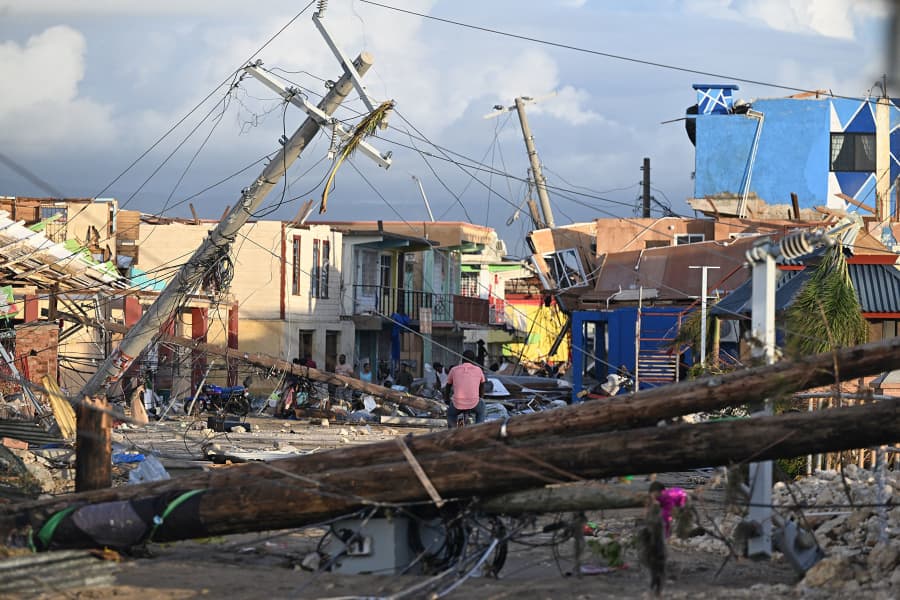 Downed electrical poles block a street in Black River, Jamaica (test)
