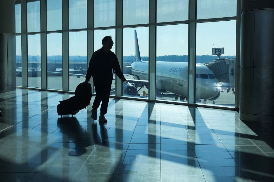 A traveler walks through Hartsfield-Jackson Atlanta International Airport on November 7, 2025 in Atlanta.