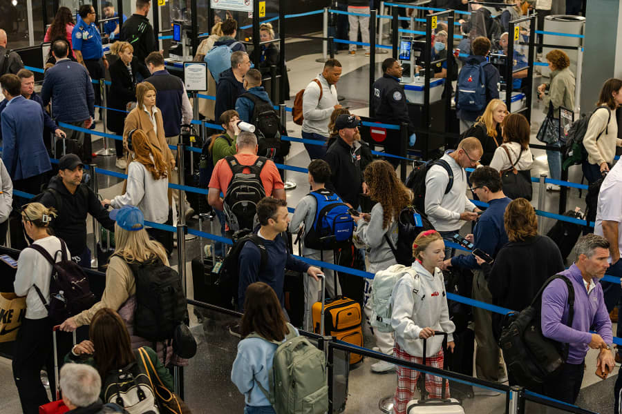 Travelers wait in a security check point line at O'Hare International Airport 