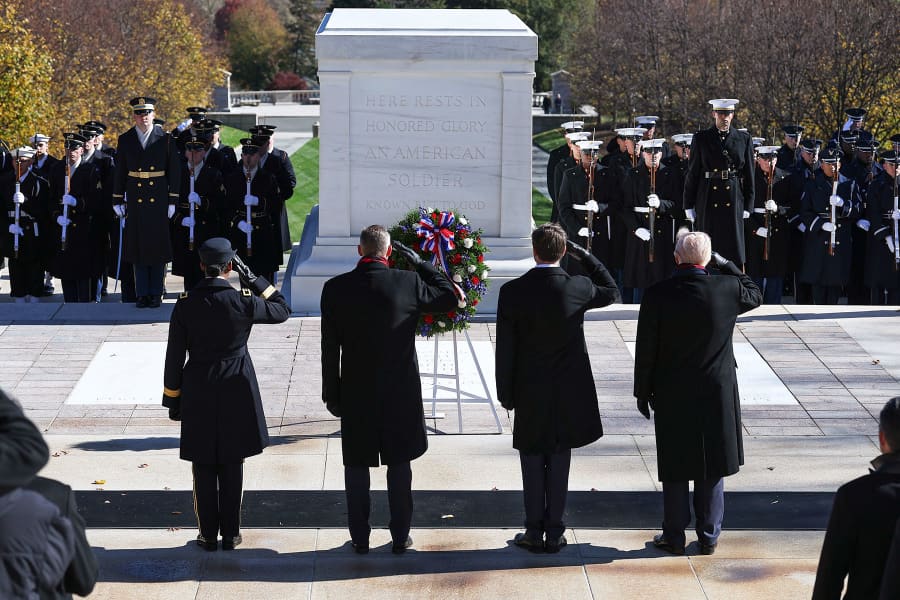 Vice President JD Vance, second from right, and President Donald Trump salute during a wreath-laying ceremony at The Tomb of the Unknown Soldier 