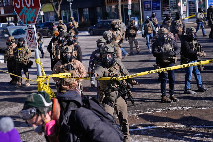Federal immigration officers deploy pepper spray at observers after a shooting Saturday, Jan. 24, 2026, in Minneapolis. 