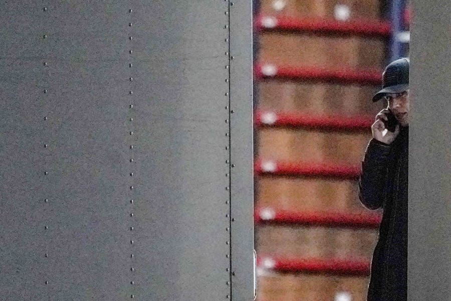 Director of National Intelligence Tulsi Gabbard speaks on the phone while standing inside a vehicle loaded with boxes outside the Fulton County Election Hub and Operation Center in Union City, Ga., on Jan. 28, 2026.