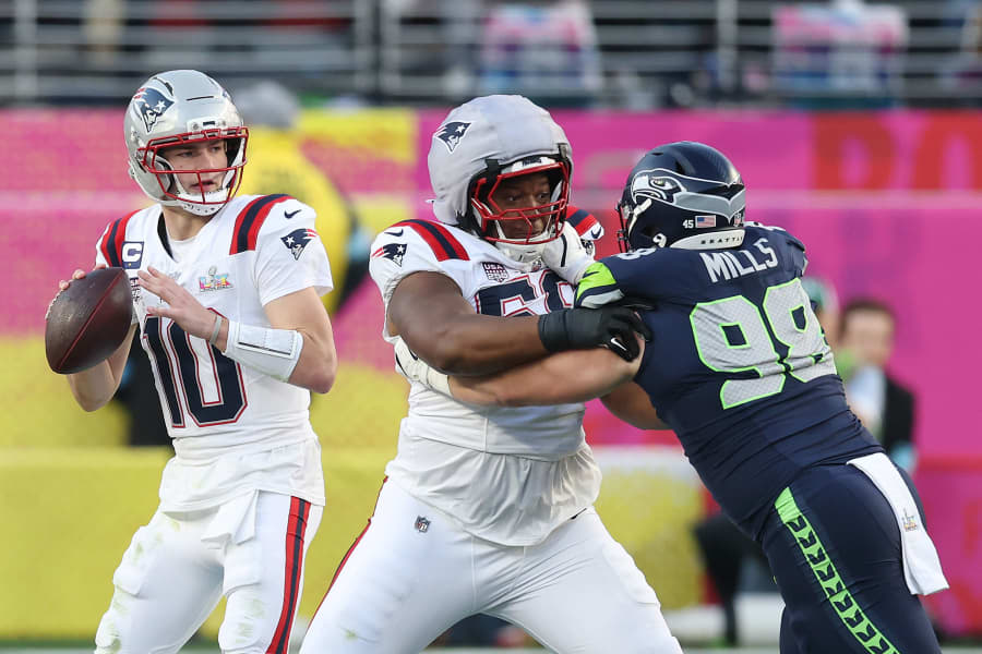 Drake Maye #10 of the New England Patriots looks to pass 