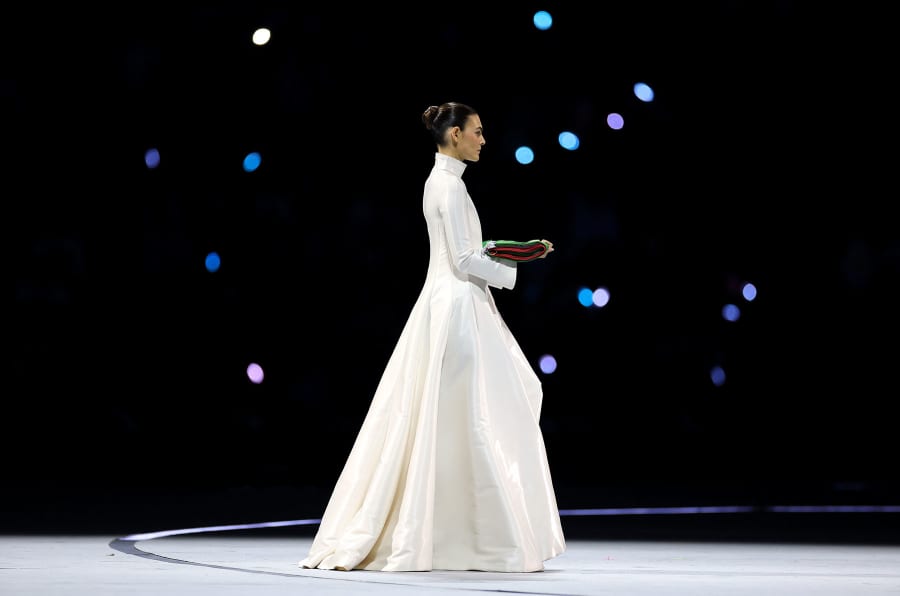 Vittoria Cerett carries the Italian flag.