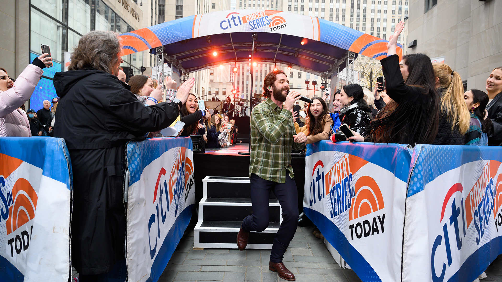 Thomas Rhett performing in a lively concert setting in [year]