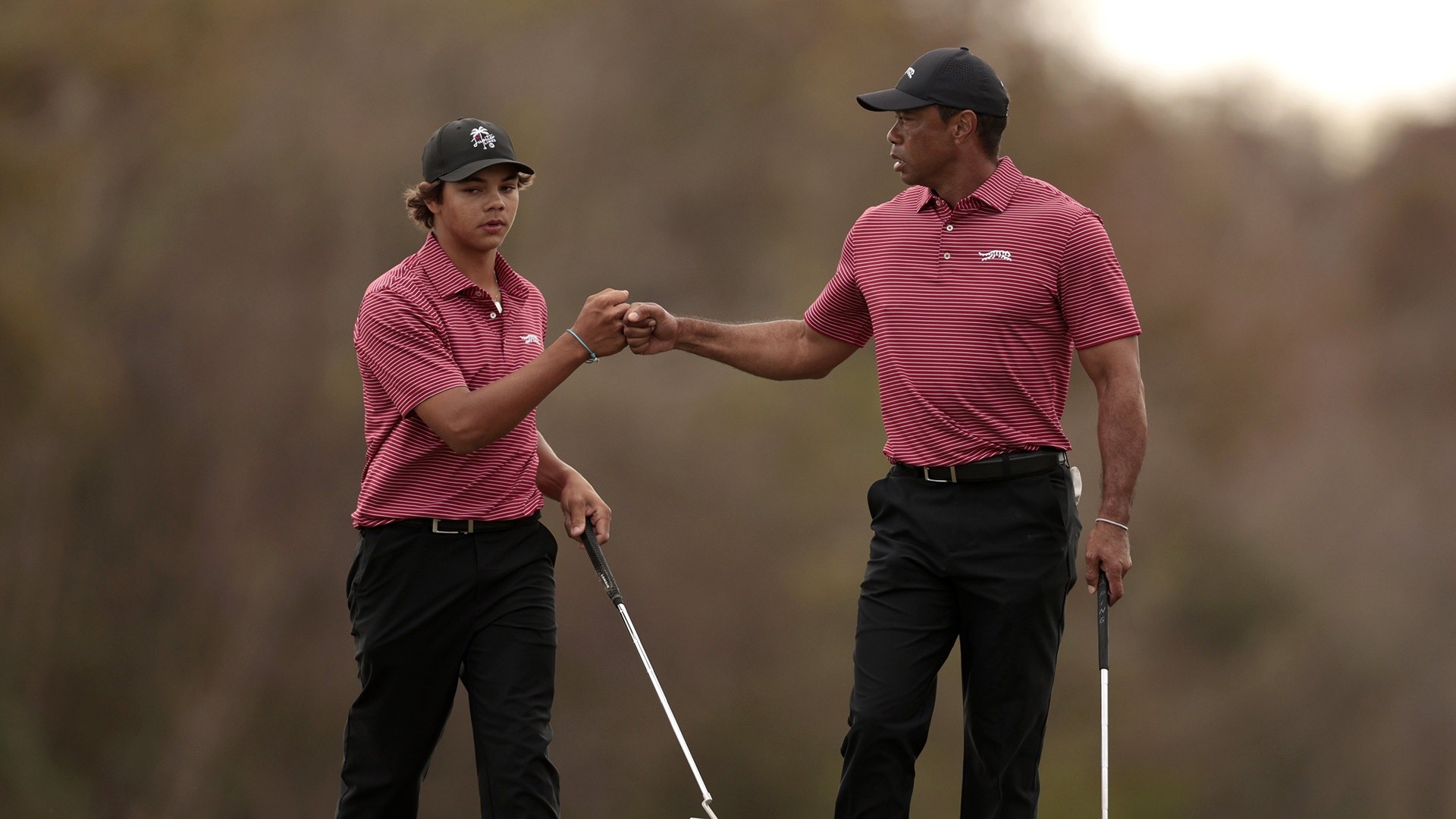 Charlie Woods celebrates with dad Tiger after his first hole-in-one