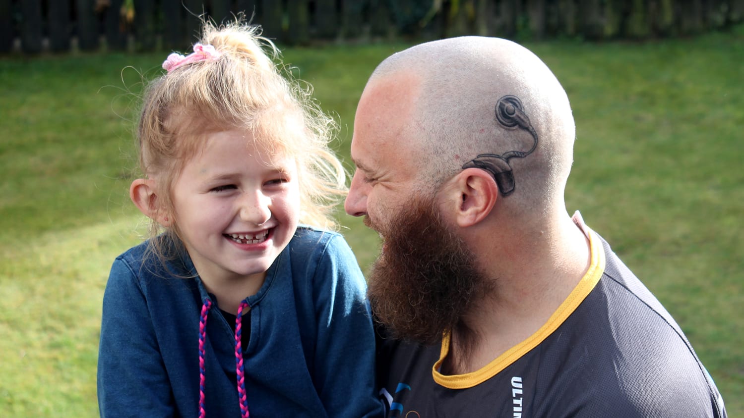 Dad gets cochlear implant tattoo to match deaf daughter's device