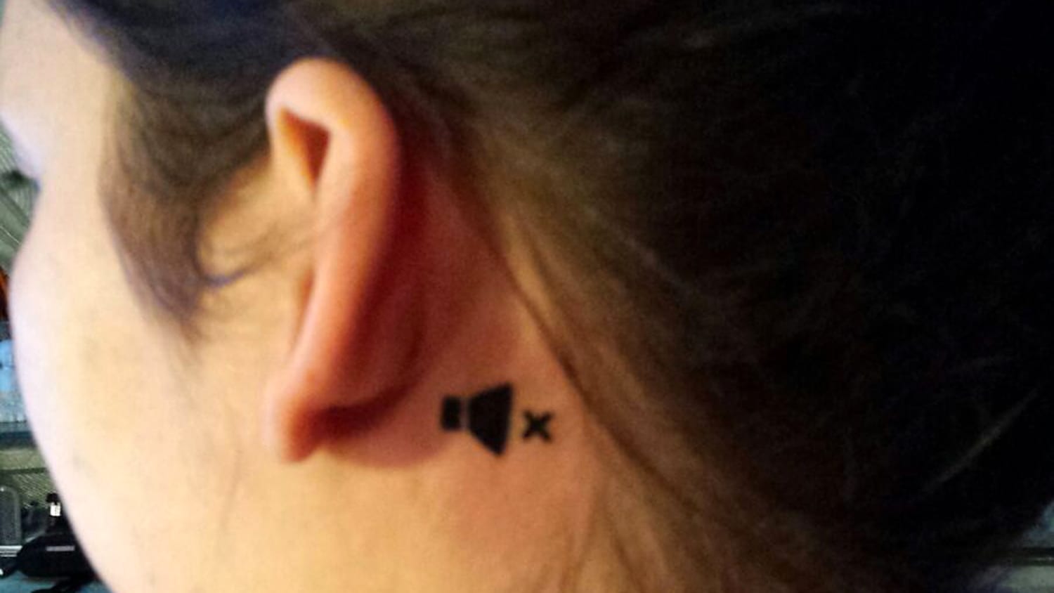Tiny airplane tattoo on the right ear