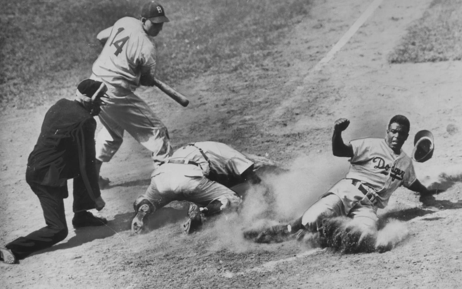 A barrage of racial slurs is directed at Jackie Robinson by the Cincinnati  fans at Crosley Field Brooklyn shortstop Pee Wee Reese, a Southerner from  Kentucky puts his arm around his teammate's