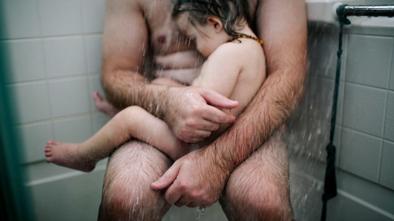 Dad and son shower together