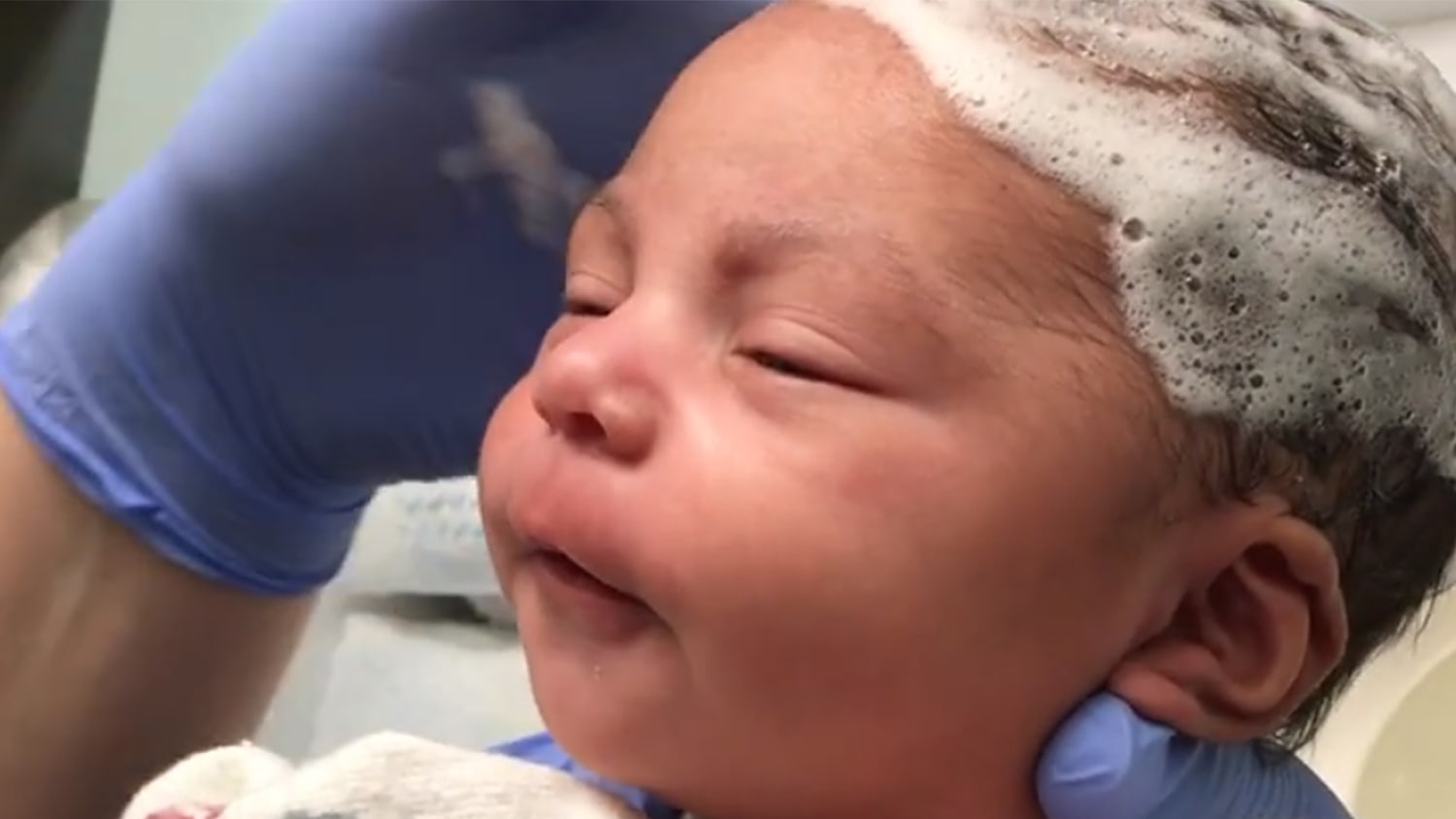 Watch blissful newborn have her hair washed for the first time