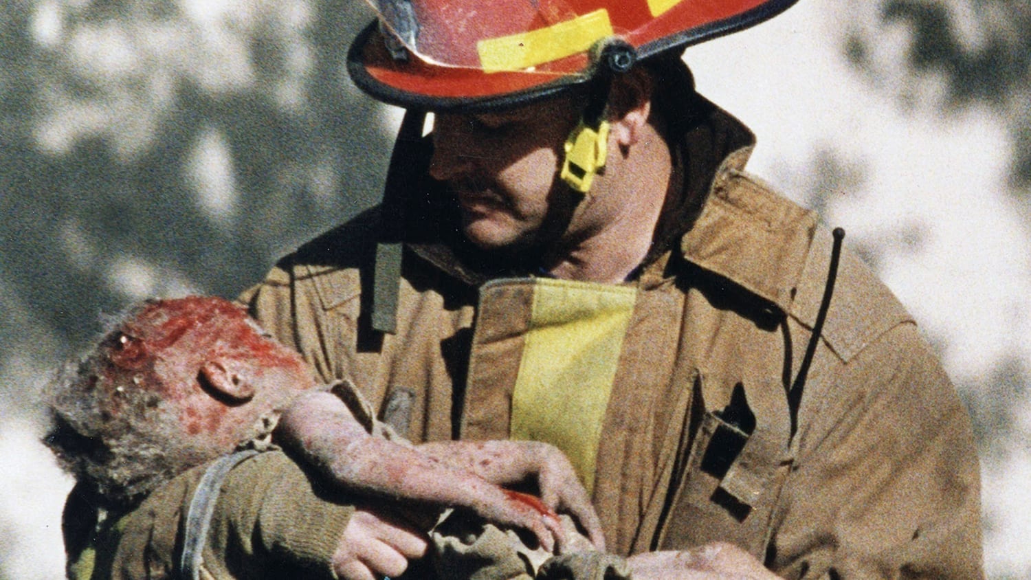 firefighter carrying baby