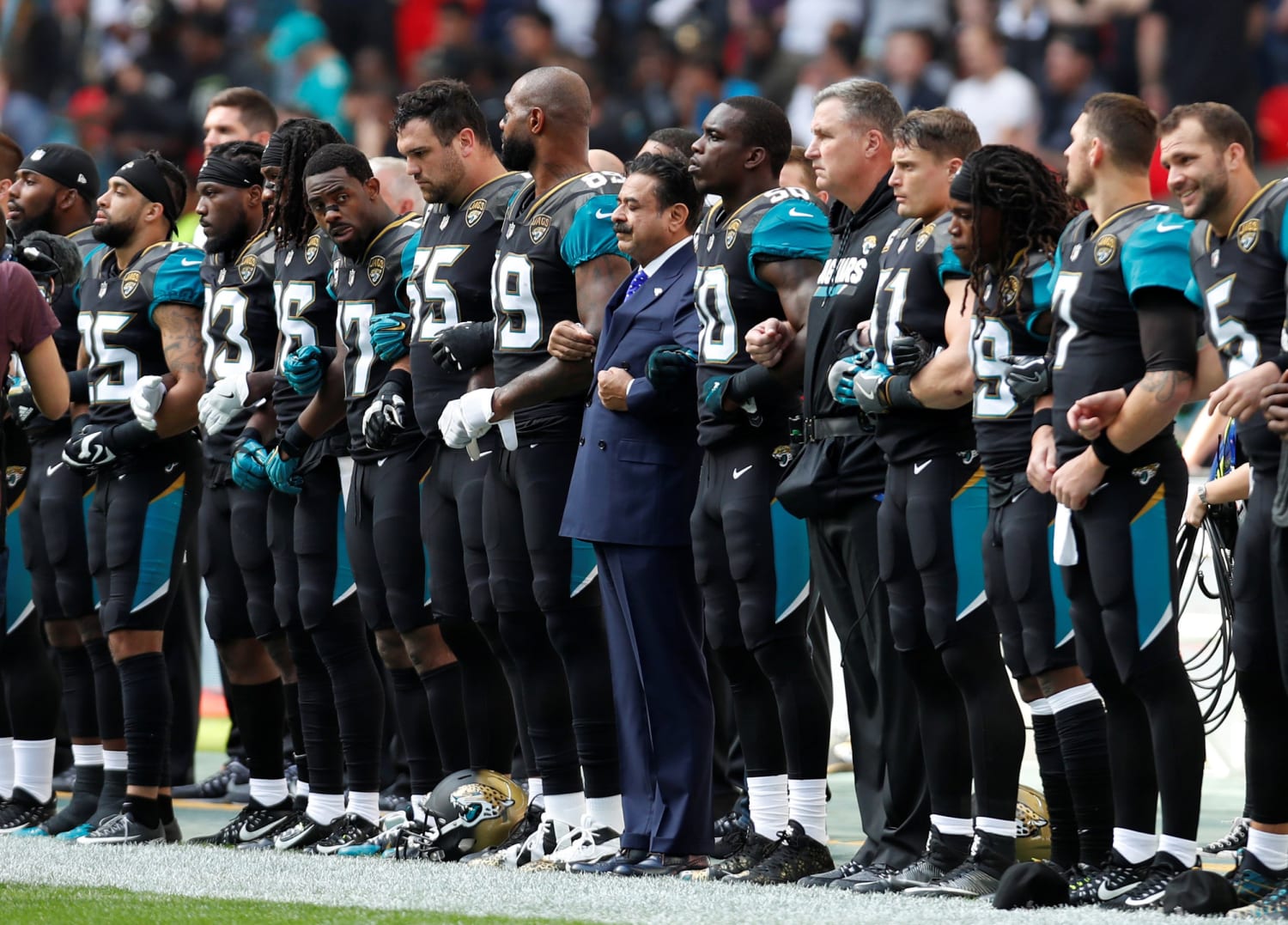 NFL Players Lock Arms, Kneel During National Anthem to Protest Trump