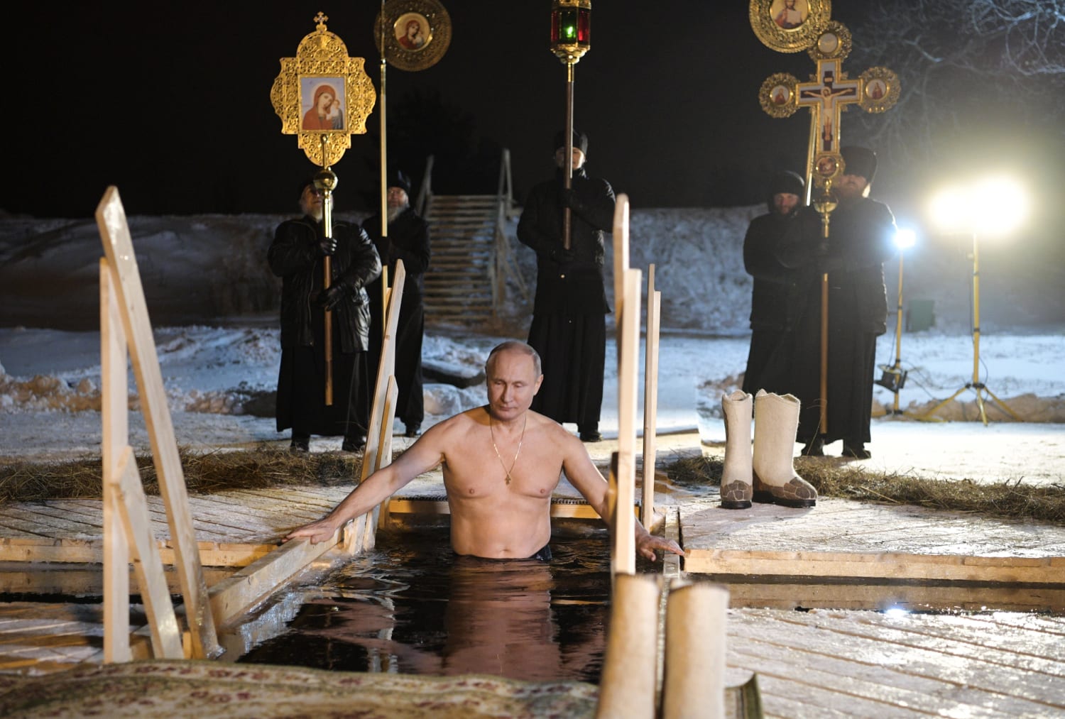 Shirtless Vladimir Putin takes dip in icy Russian lake