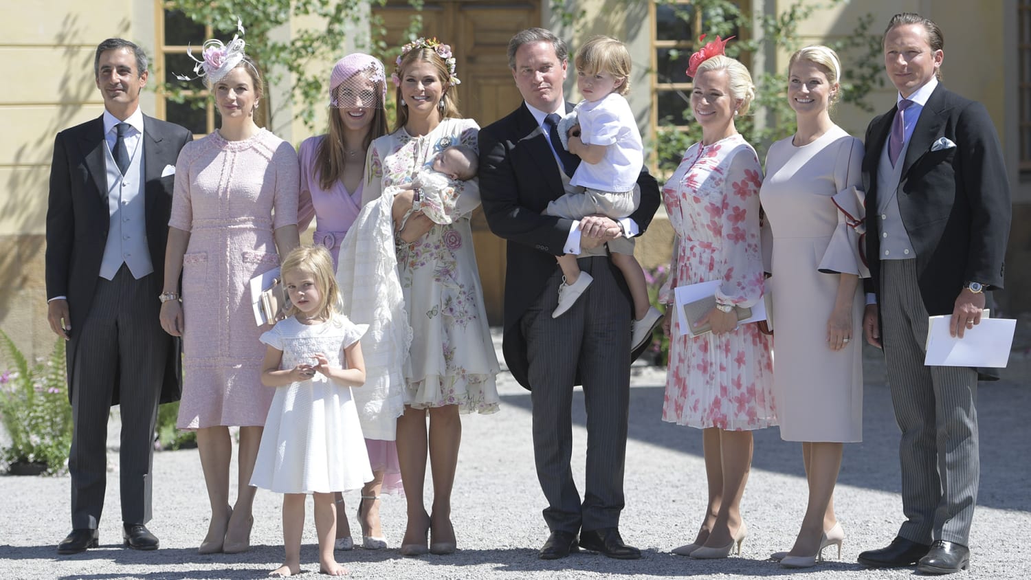 Sweden's Princess Madeleine, left holding Prince Nicolas stands