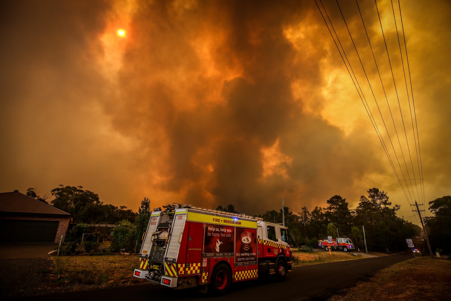 As wildfires rage, Australian PM apologizes for family vacation and defends  climate policies