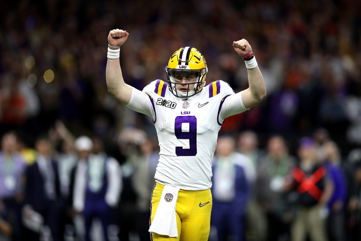 Joe Burrow LSU Tigers Unsigned White Jersey Throwing Under Spotlights  Photograph