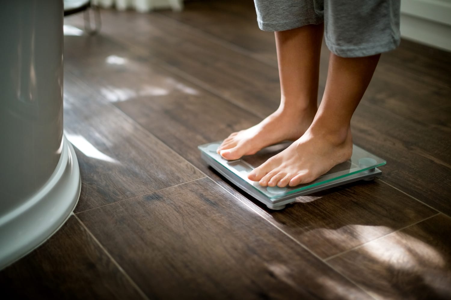 Person Standing On A Weight Scale Weighing Themselves Stock